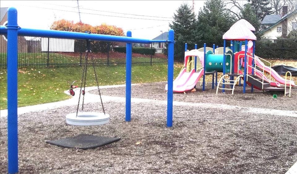 A swing set and a colorful playground structure