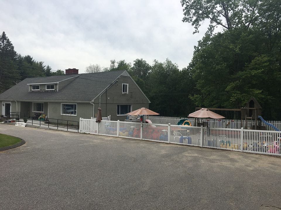 House with a fenced-in yard and playground equipment