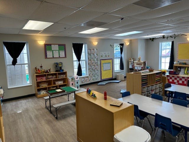 Empty classroom with small tables and chairs