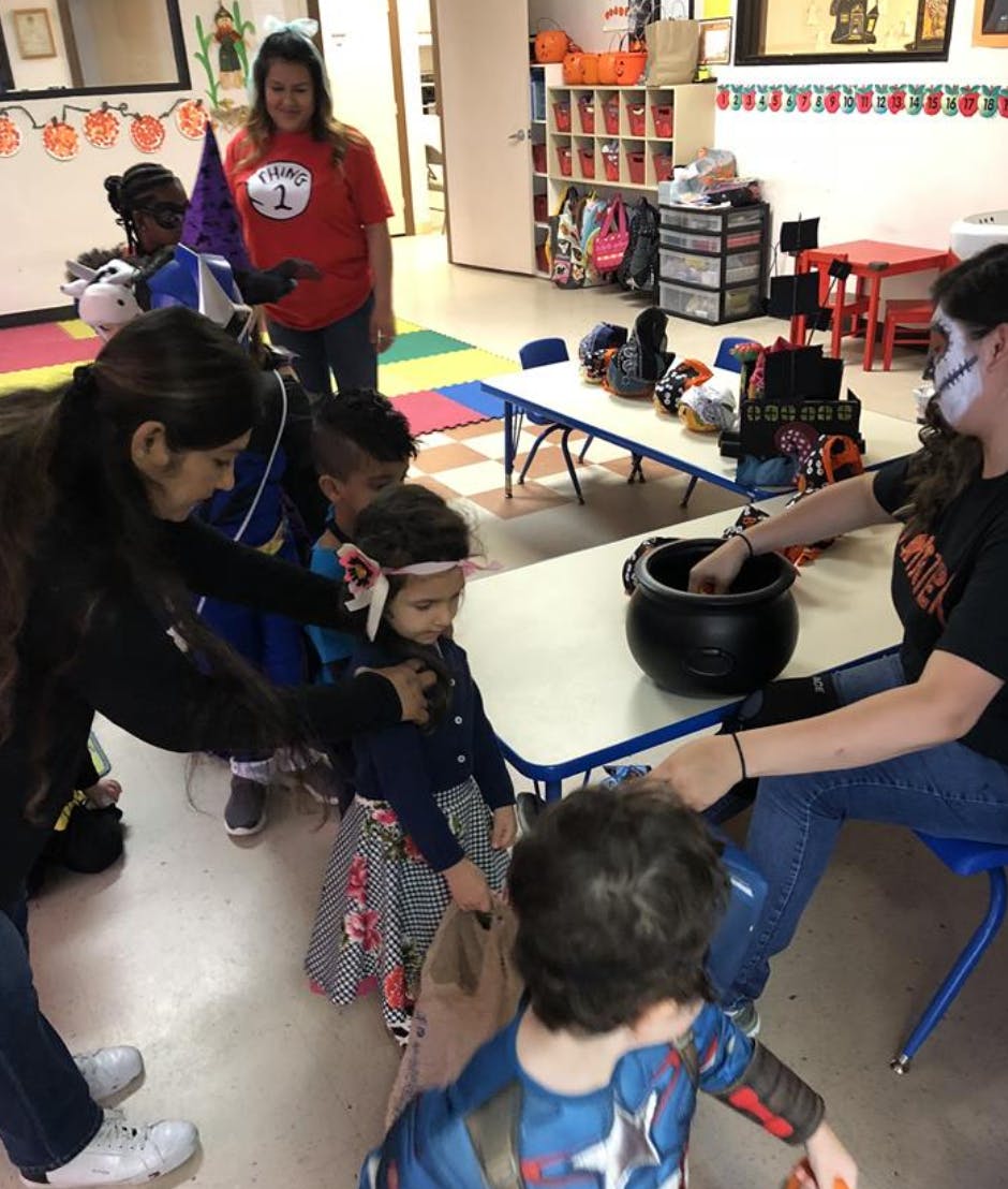 People and children in costumes in a classroom