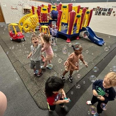 Children playing with bubbles on a playground