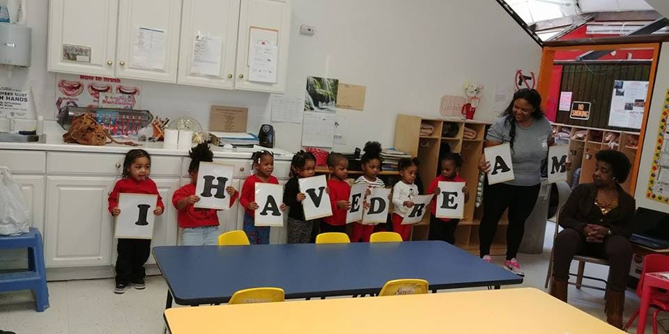 Children and adults holding up letters spelling "I HAVE A DREAM"