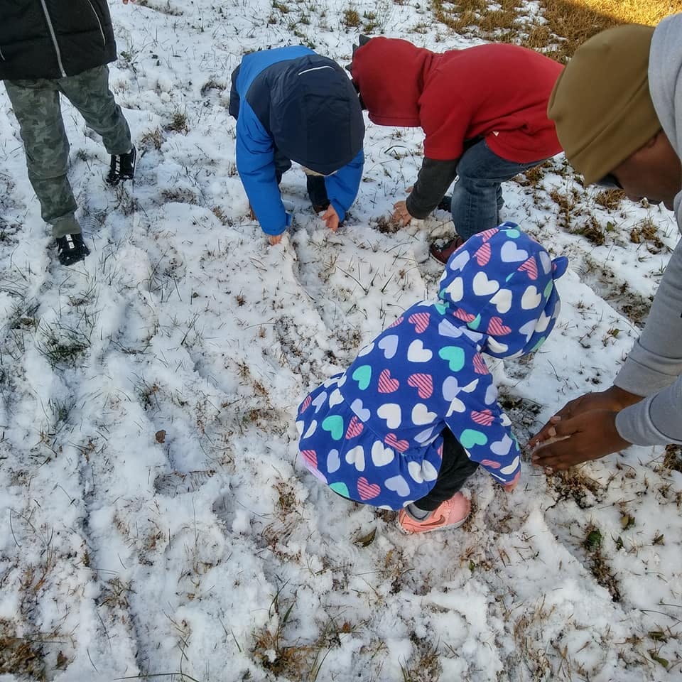 People and children playing in the snow