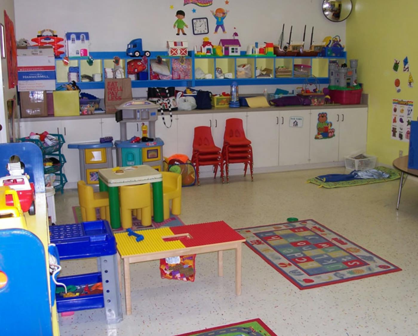 Playroom with small tables, chairs, and toys
