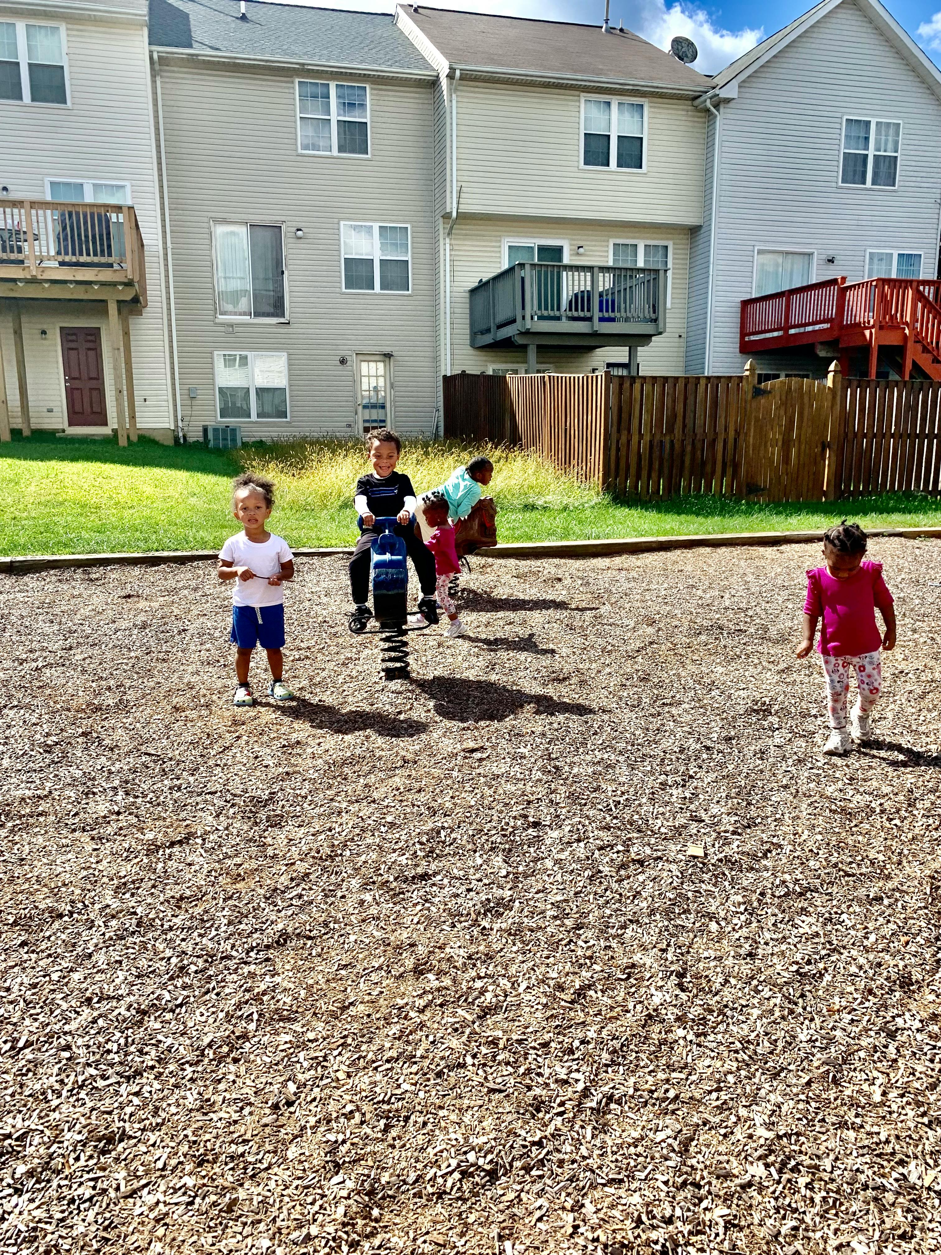 Children playing on a playground with spring riders