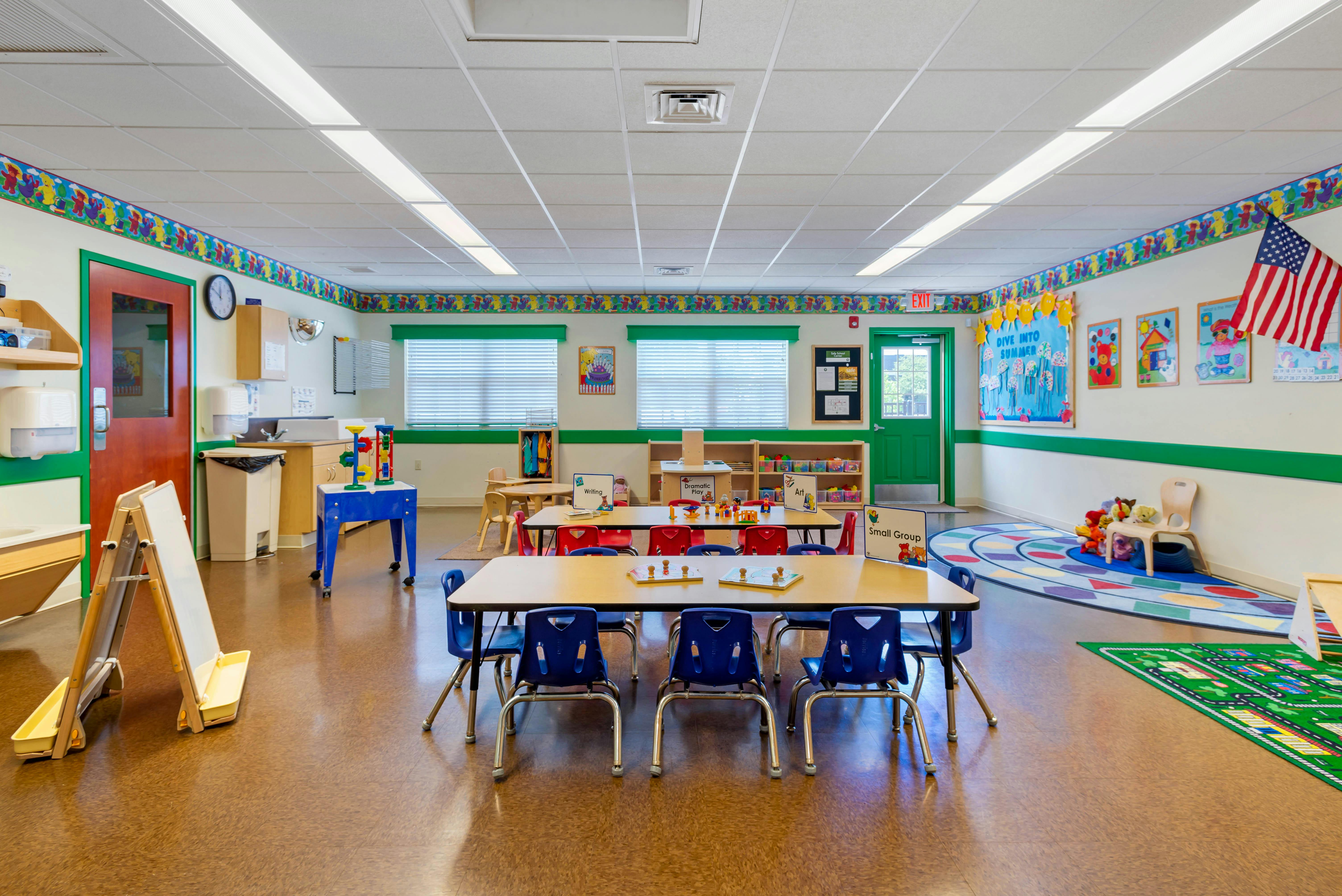 Classroom with child-sized tables and chairs, toys, and learning materials