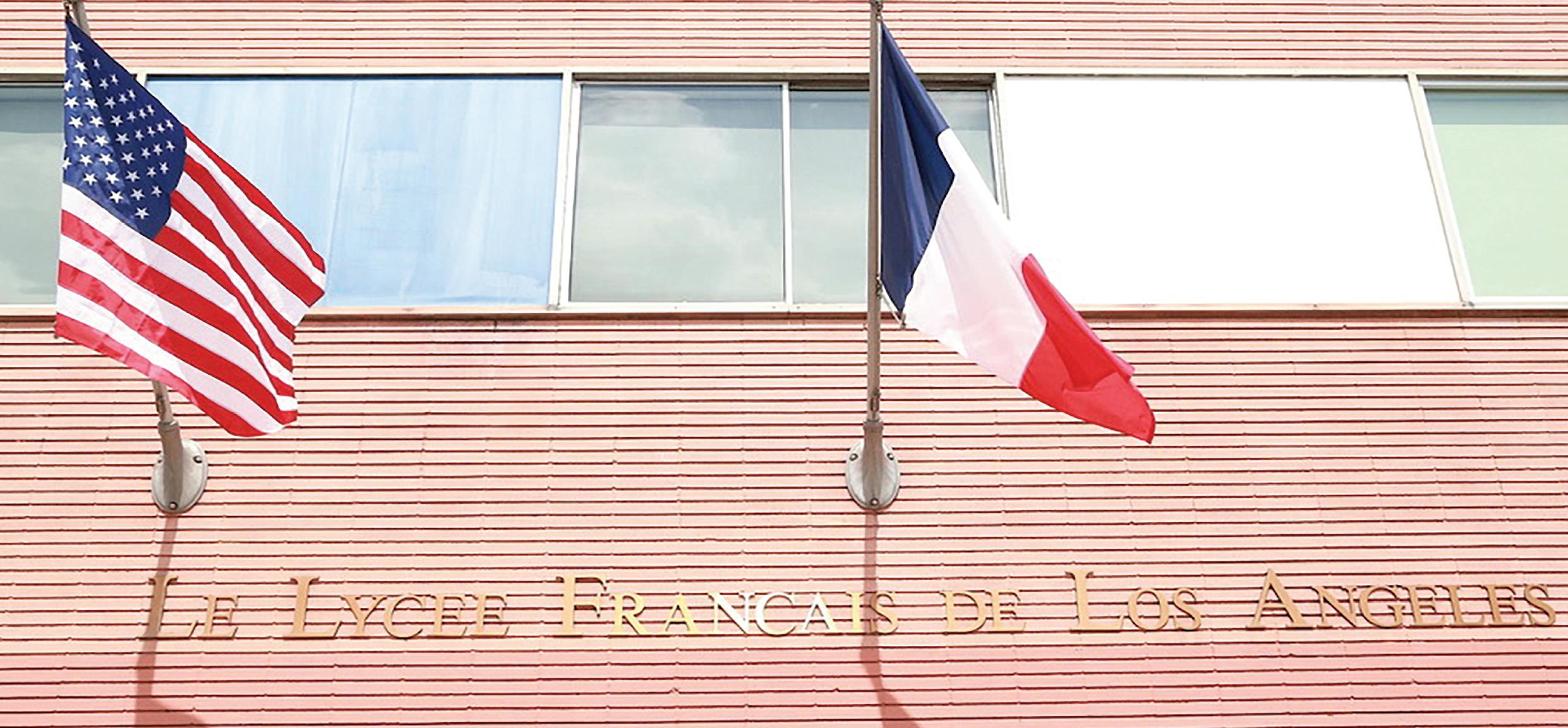 American and French flags hanging on a building