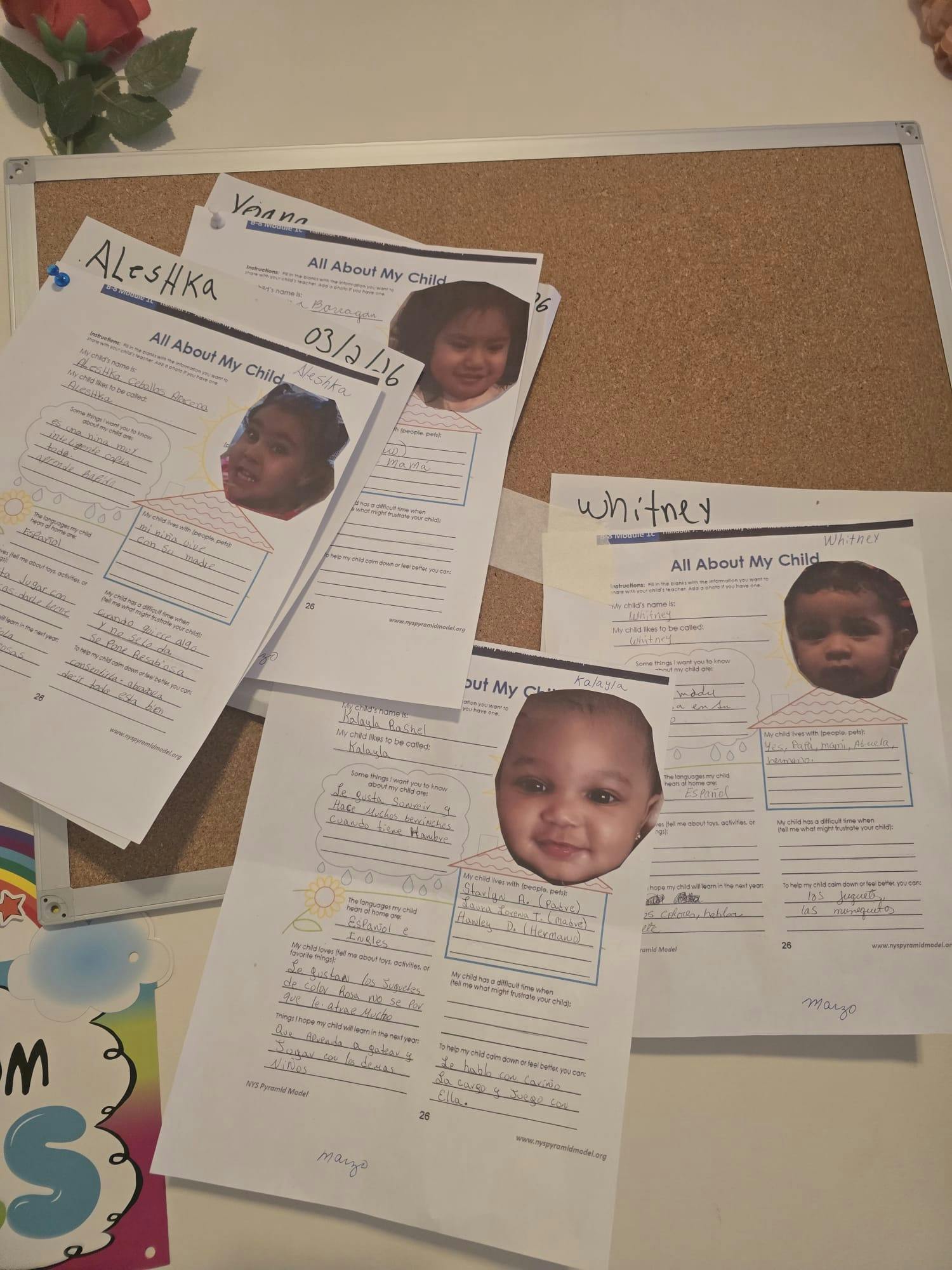 multiple "All About My Child" forms with child photos and handwritten details on a cork board