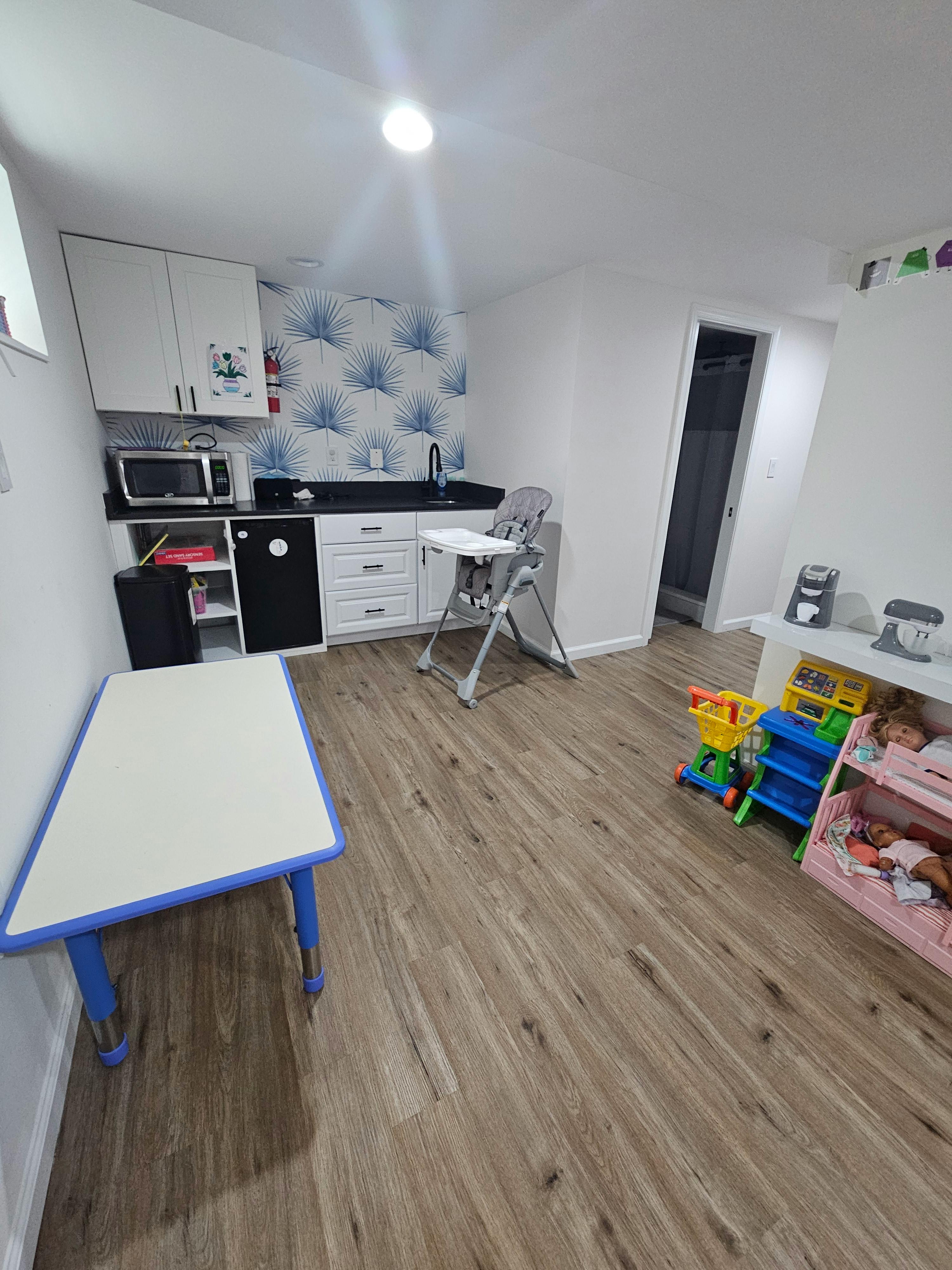 Small table and high chair in a room with play equipment