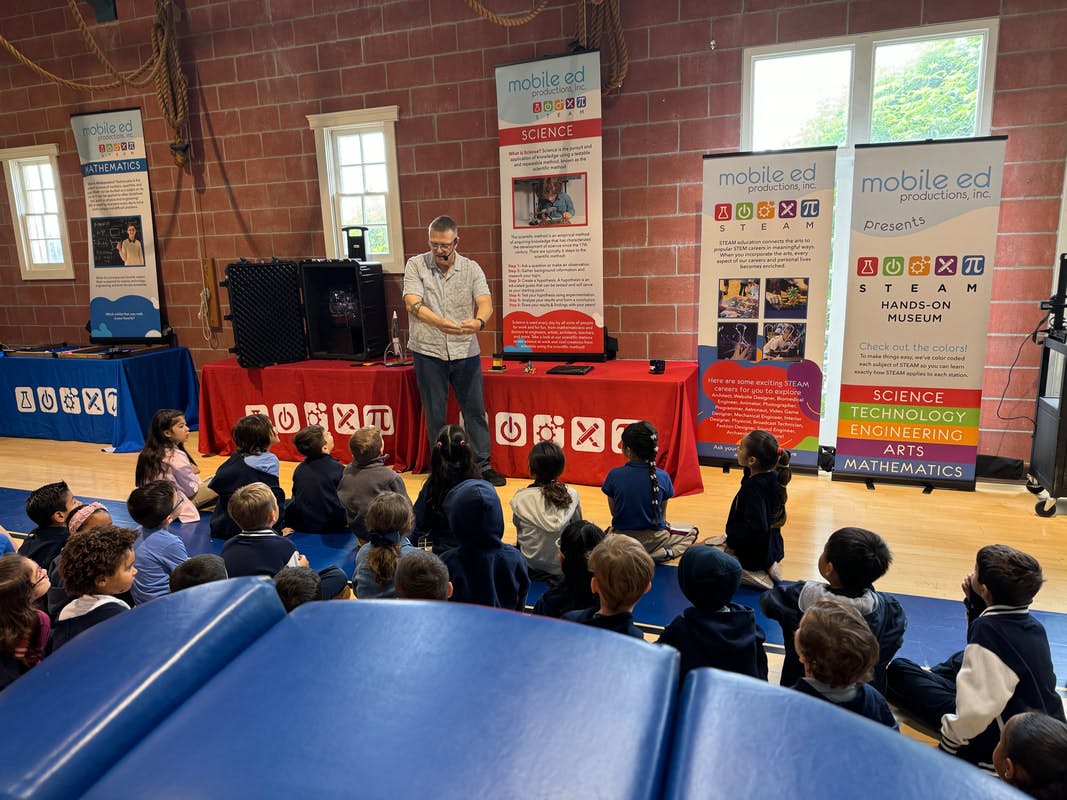 adult presenting to a group of children sitting on the floor