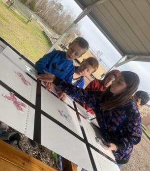 Children playing tic-tac-toe outdoors