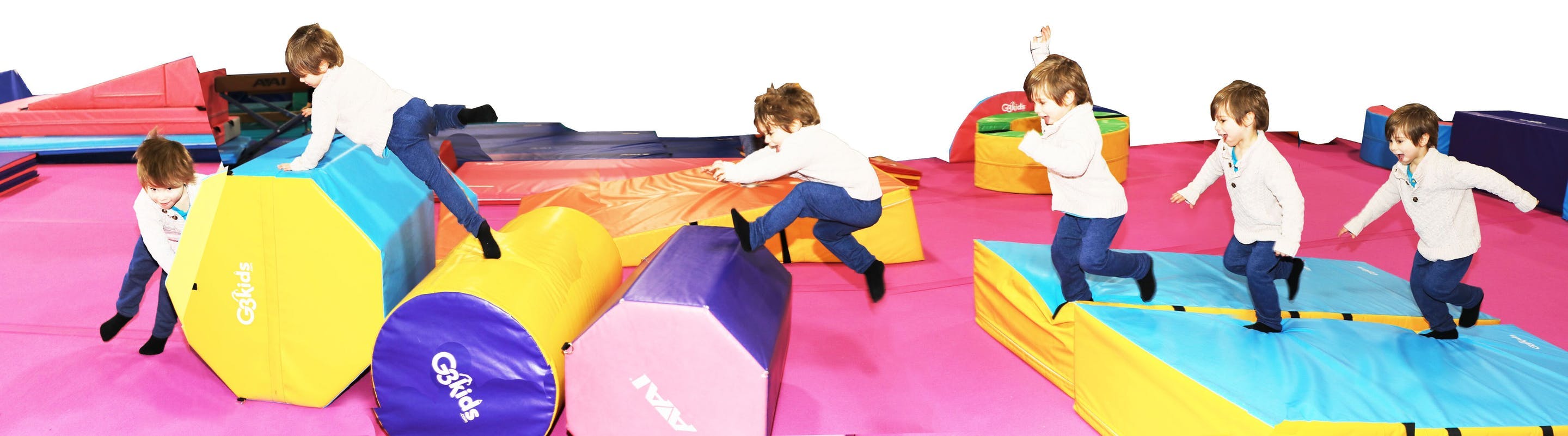 Children playing on colorful soft play equipment