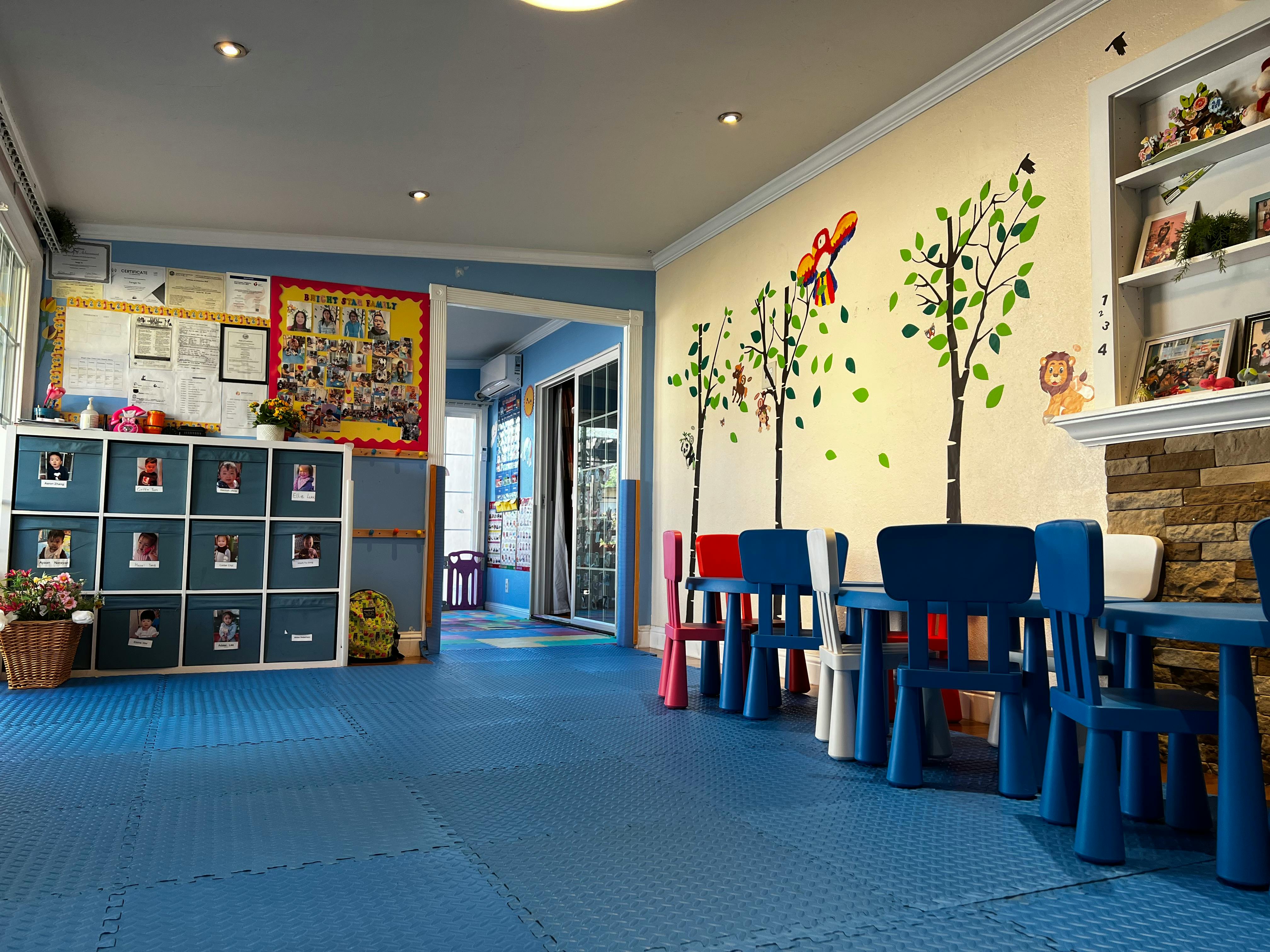 Children's classroom with small tables and chairs, storage cubbies, and wall decorations