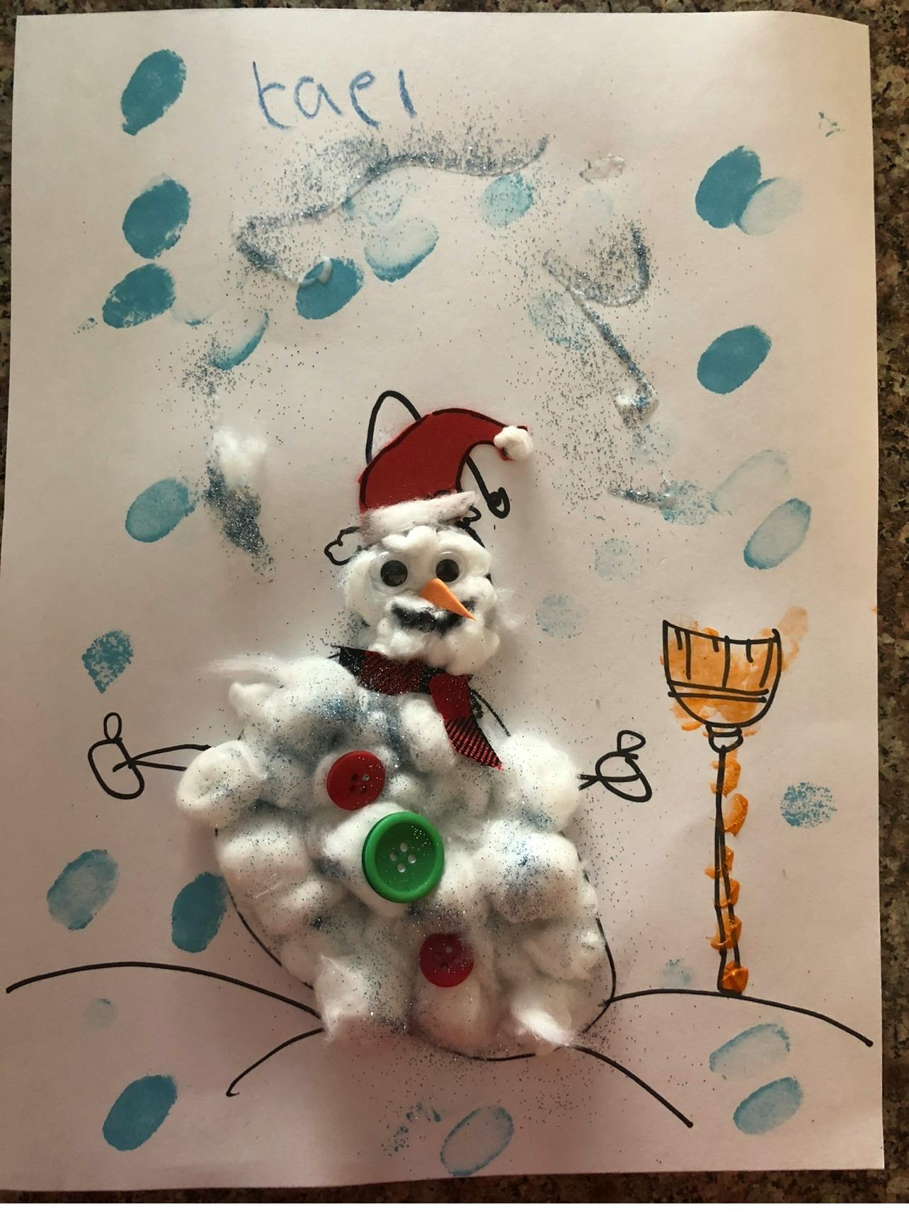Child's craft project of a snowman made from cotton, buttons, and glitter