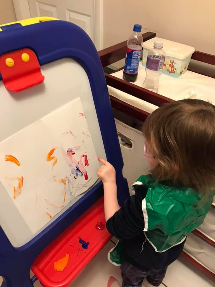 Child painting on an easel