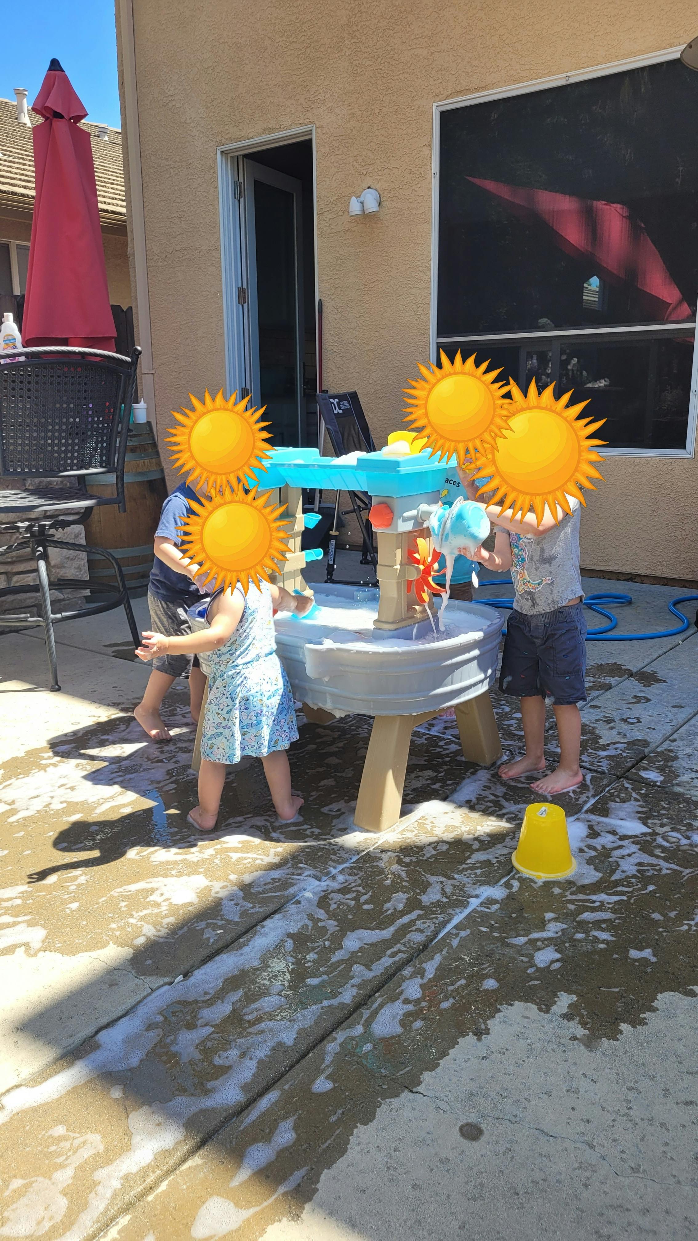 Children playing with a water table outdoors
