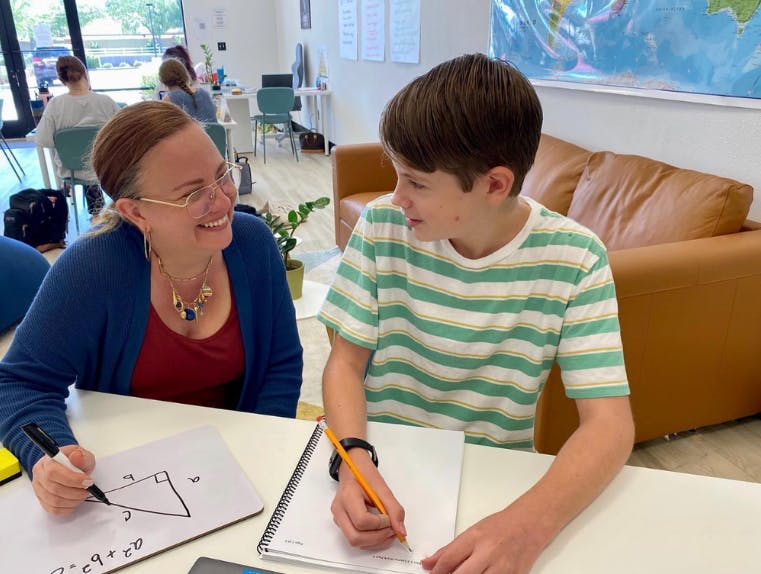 Adult and child working on math problems at a table