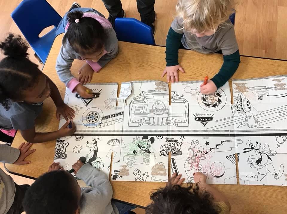 Children coloring at a table