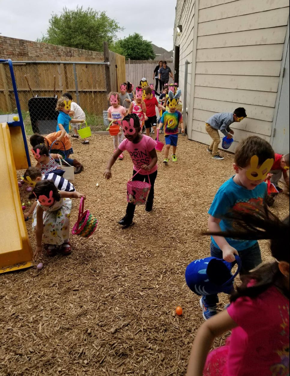Children in animal masks collecting items in baskets outdoors area with buckets outdoors