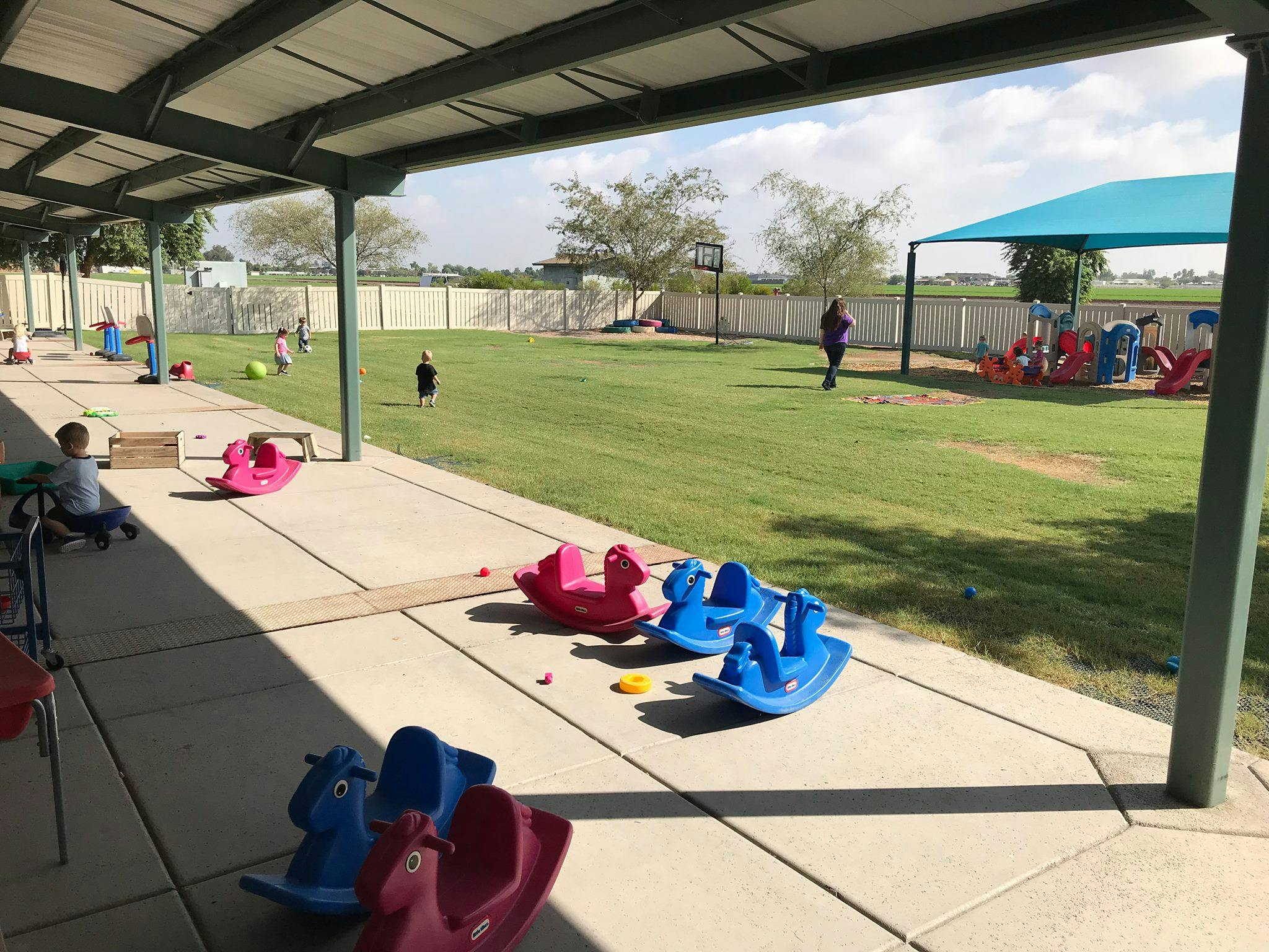 Children playing on a playground with rocking toys
