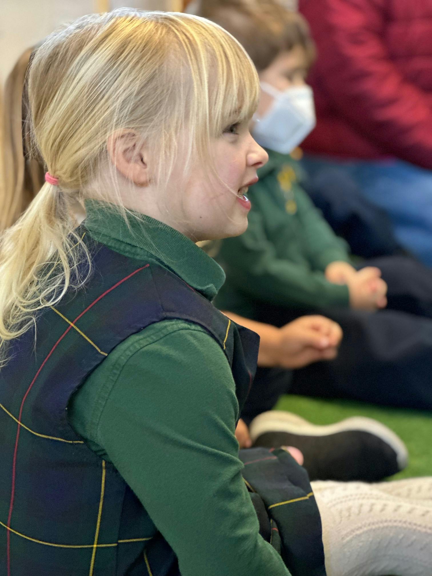 Child with blonde hair looking to the right