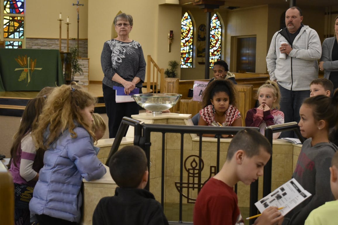Adults and children gathered in a church