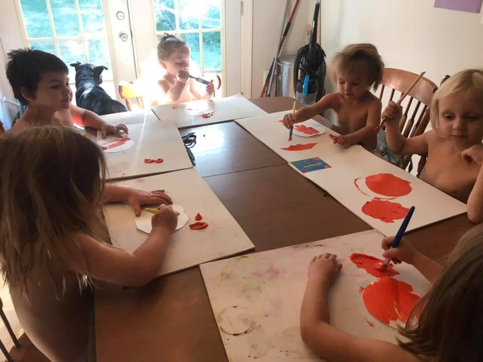 Multiple children painting at a table