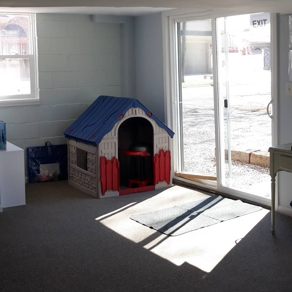 Toy playhouse next to a sliding glass door