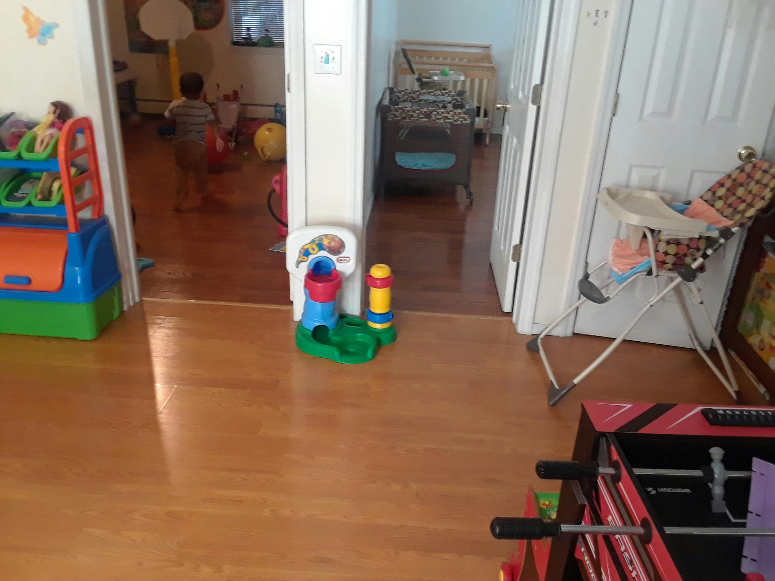 Child standing in a room with toys