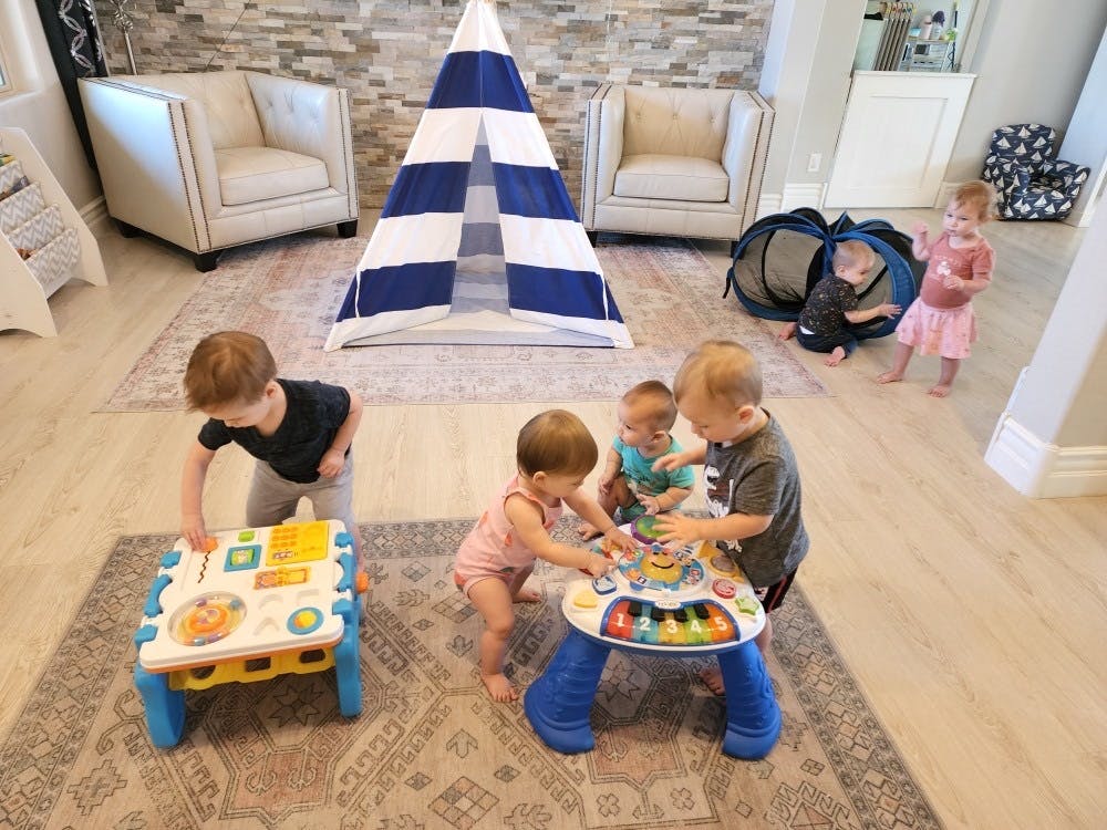 Multiple children playing with toys in a room