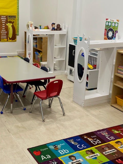 Classroom with tables, chairs, and play furniture