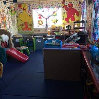 Playroom with a red slide and colorful decorations