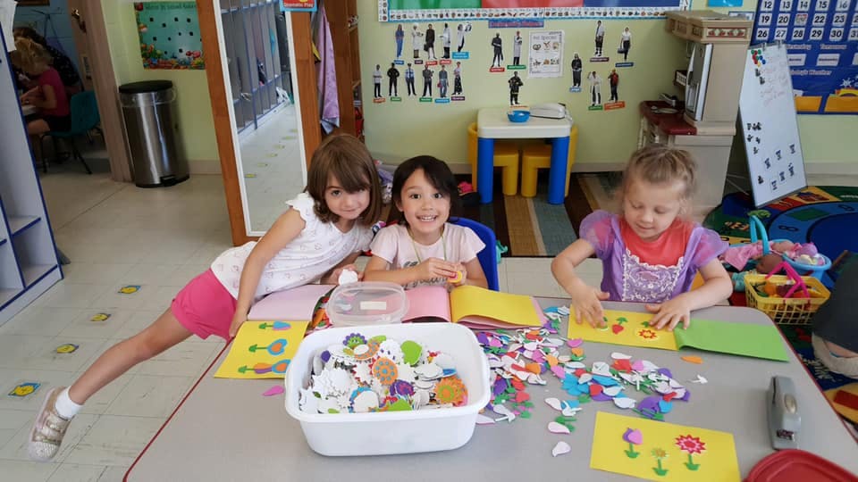 Three children doing crafts at a table