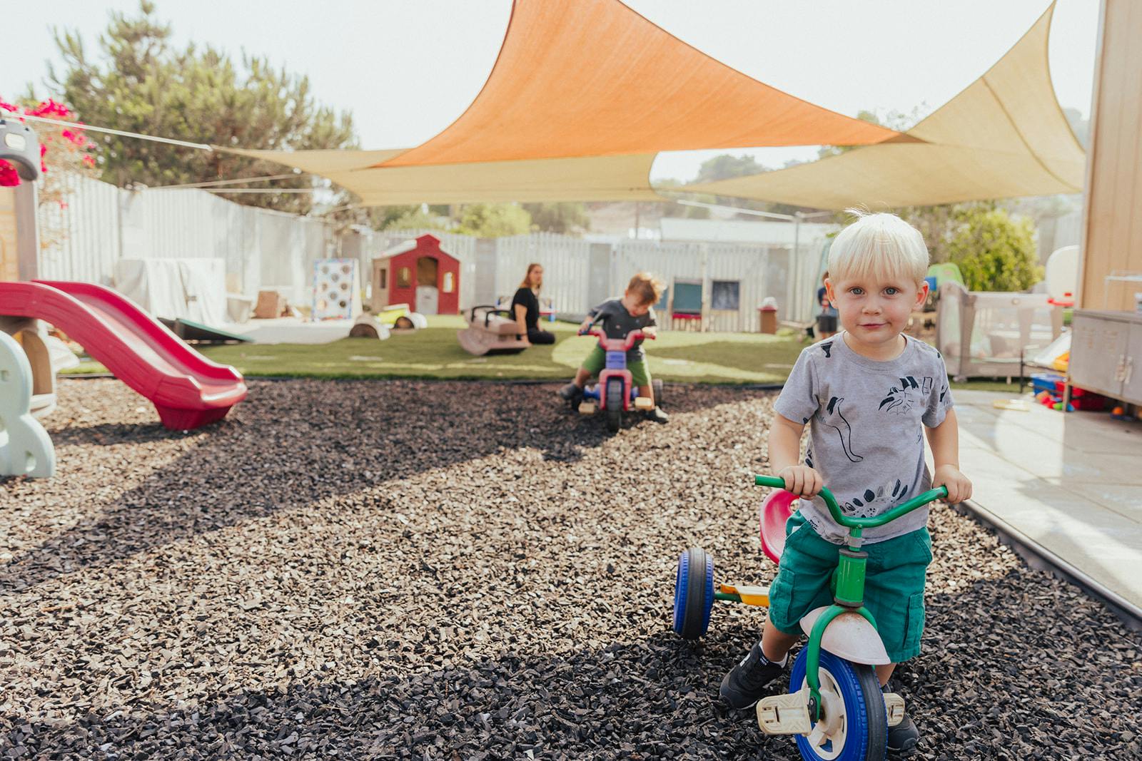Child on a tricycle in a playground