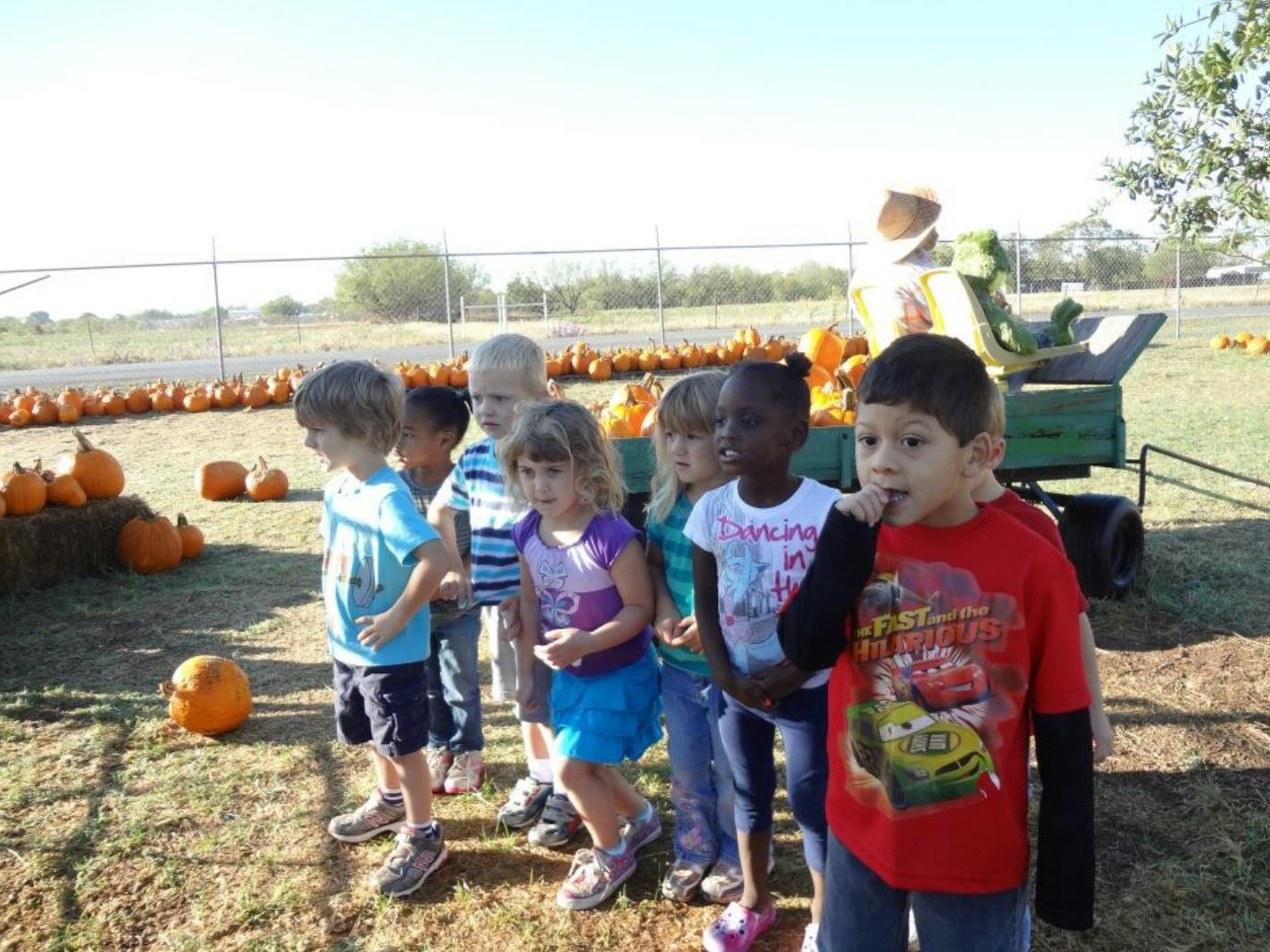Group of children standing in a pumpkin patch