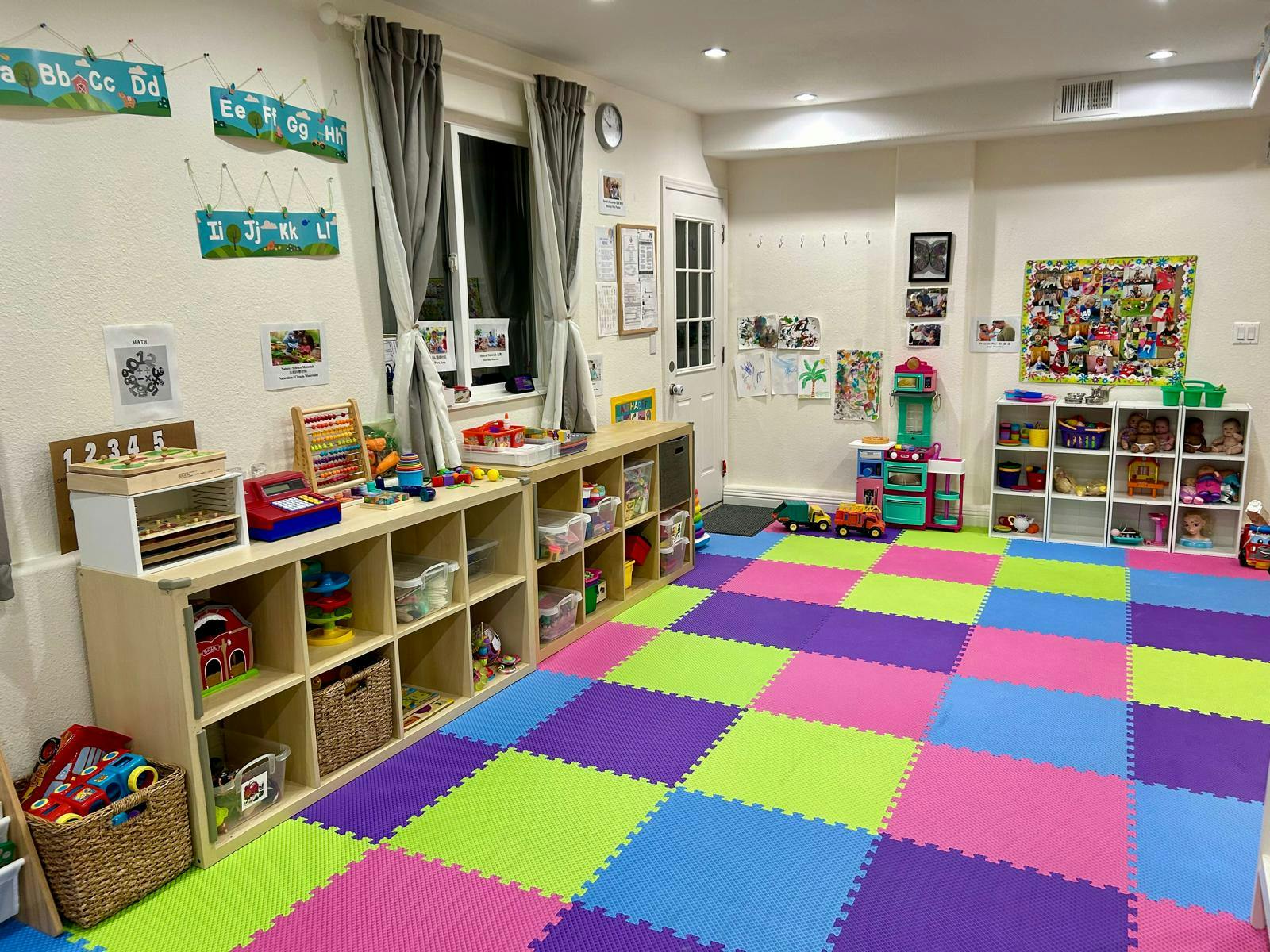 Playroom with colorful floor mats and shelves filled with toys
