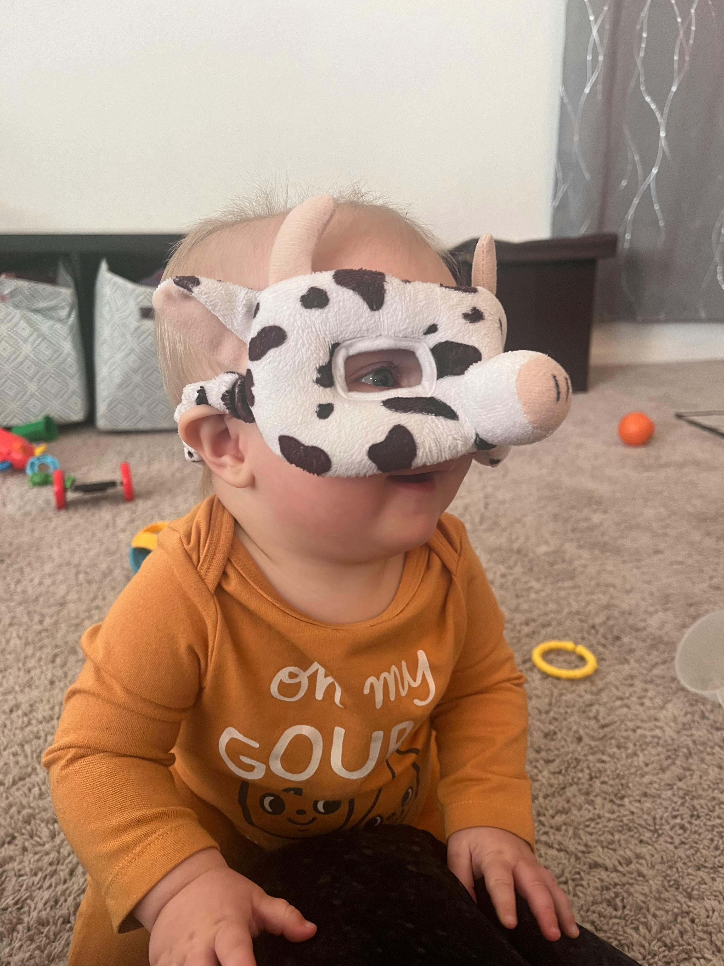 Child wearing a cow mask