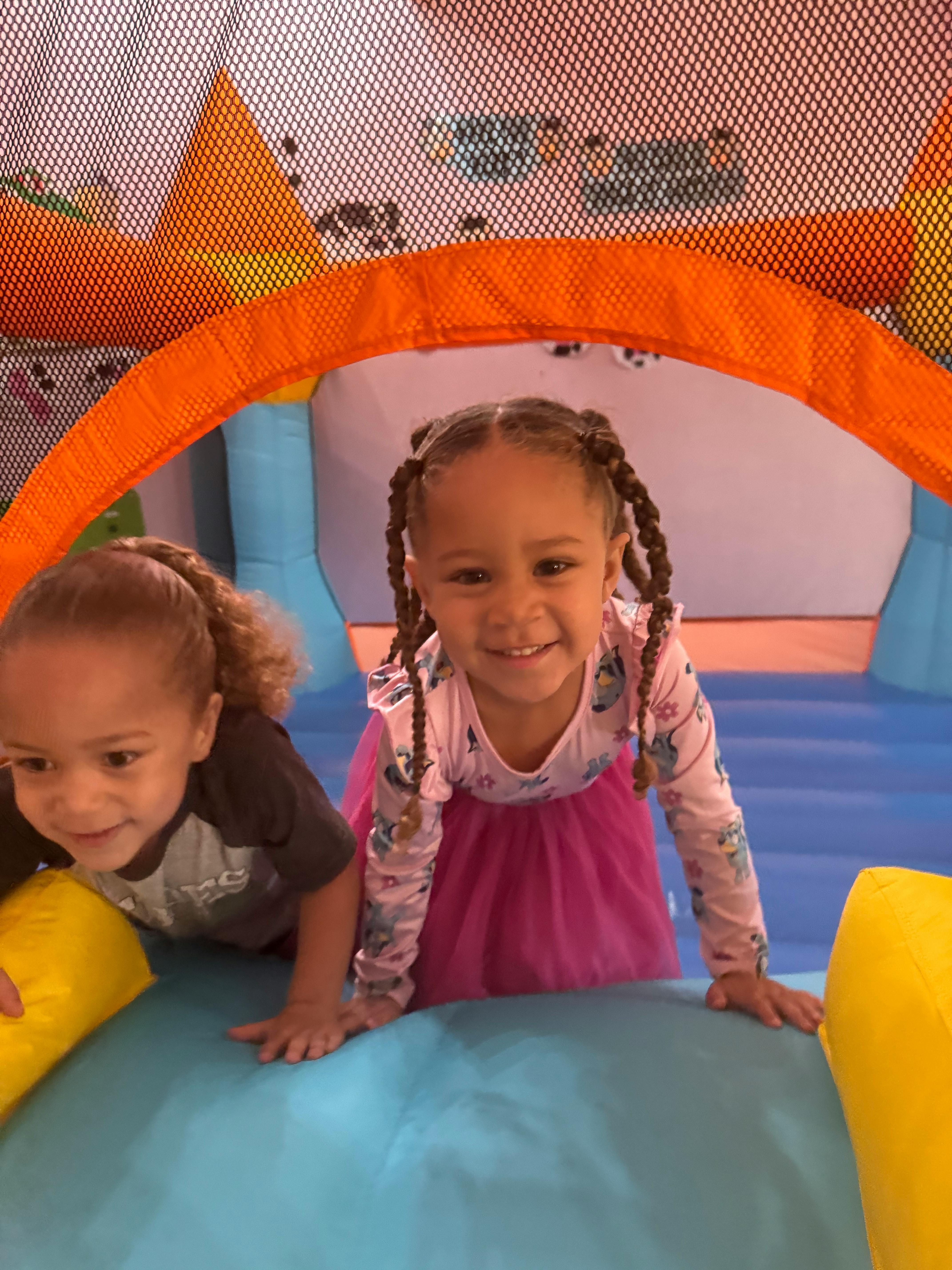 Two children playing in an inflatable bounce house