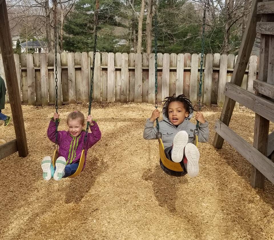 Two children on swings at a playground