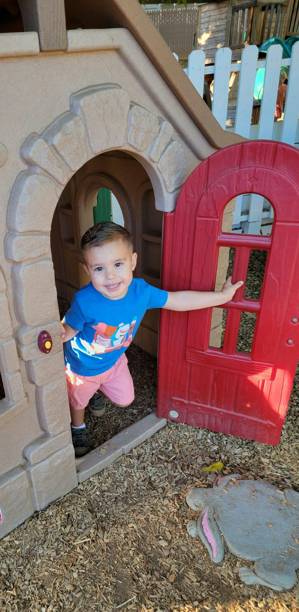 Child in a playhouse doorway