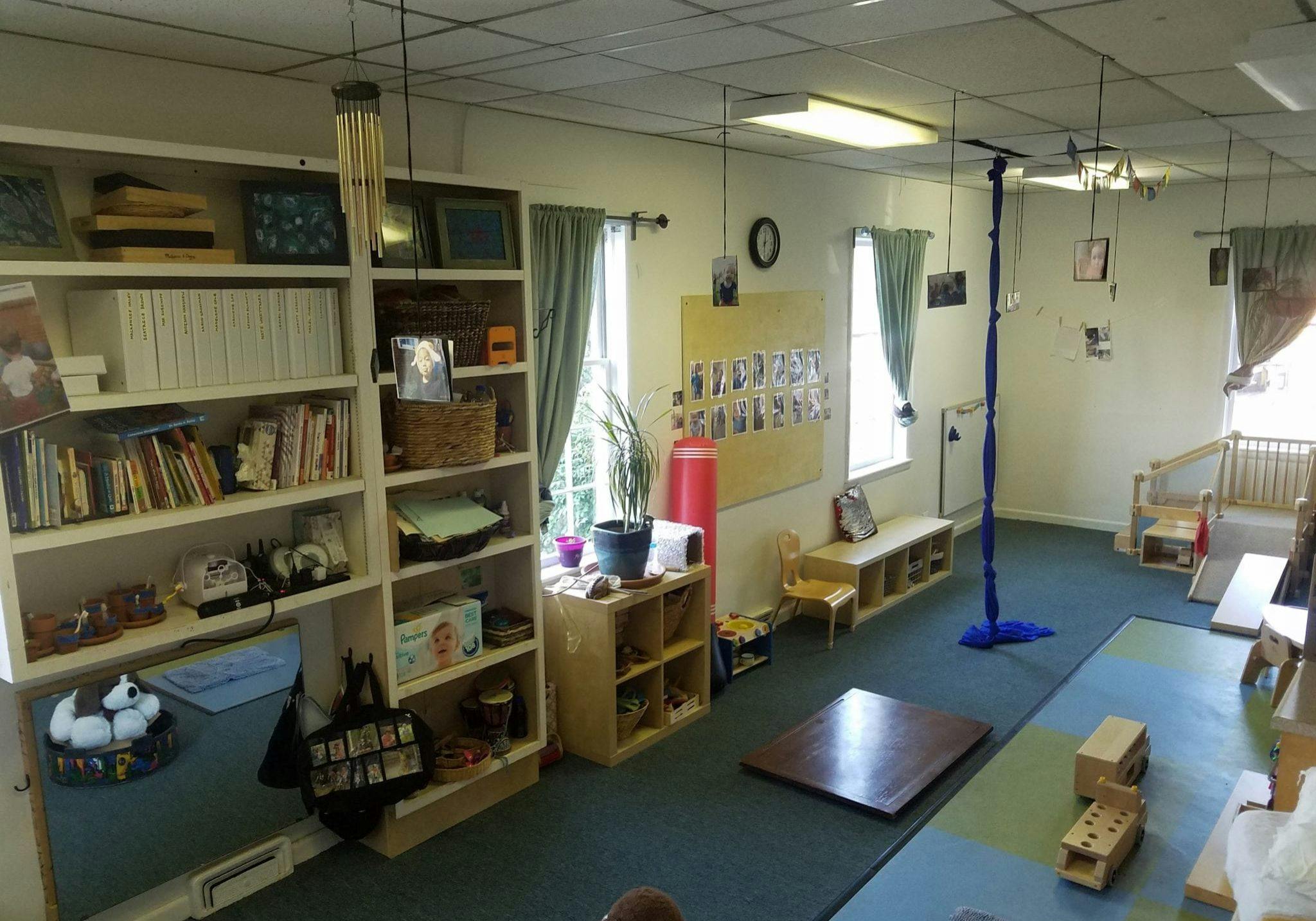 Classroom with bookshelves, windows, and play areas