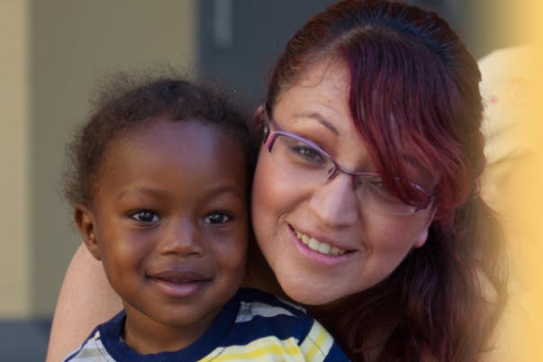 Person with glasses and child smiling