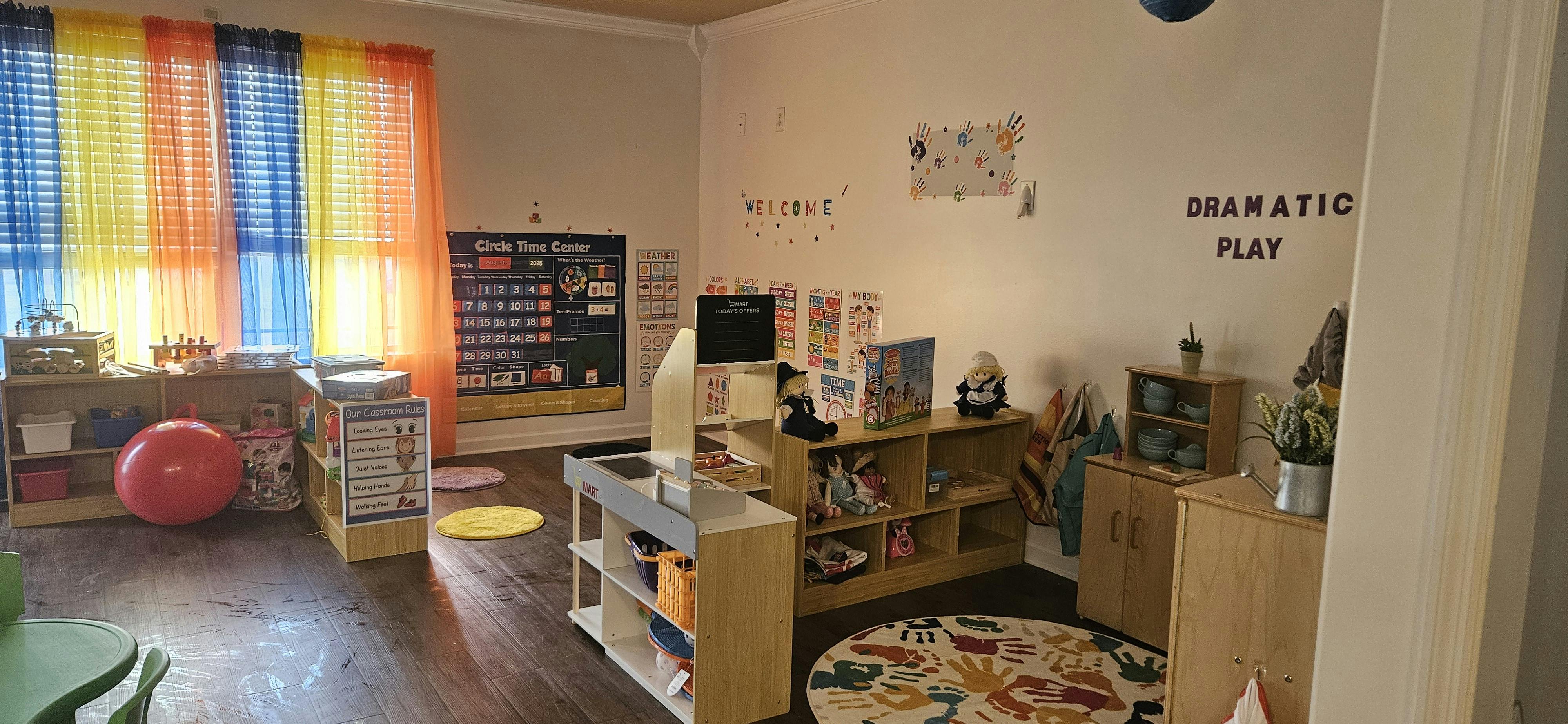Classroom with colorful curtains and various play areas