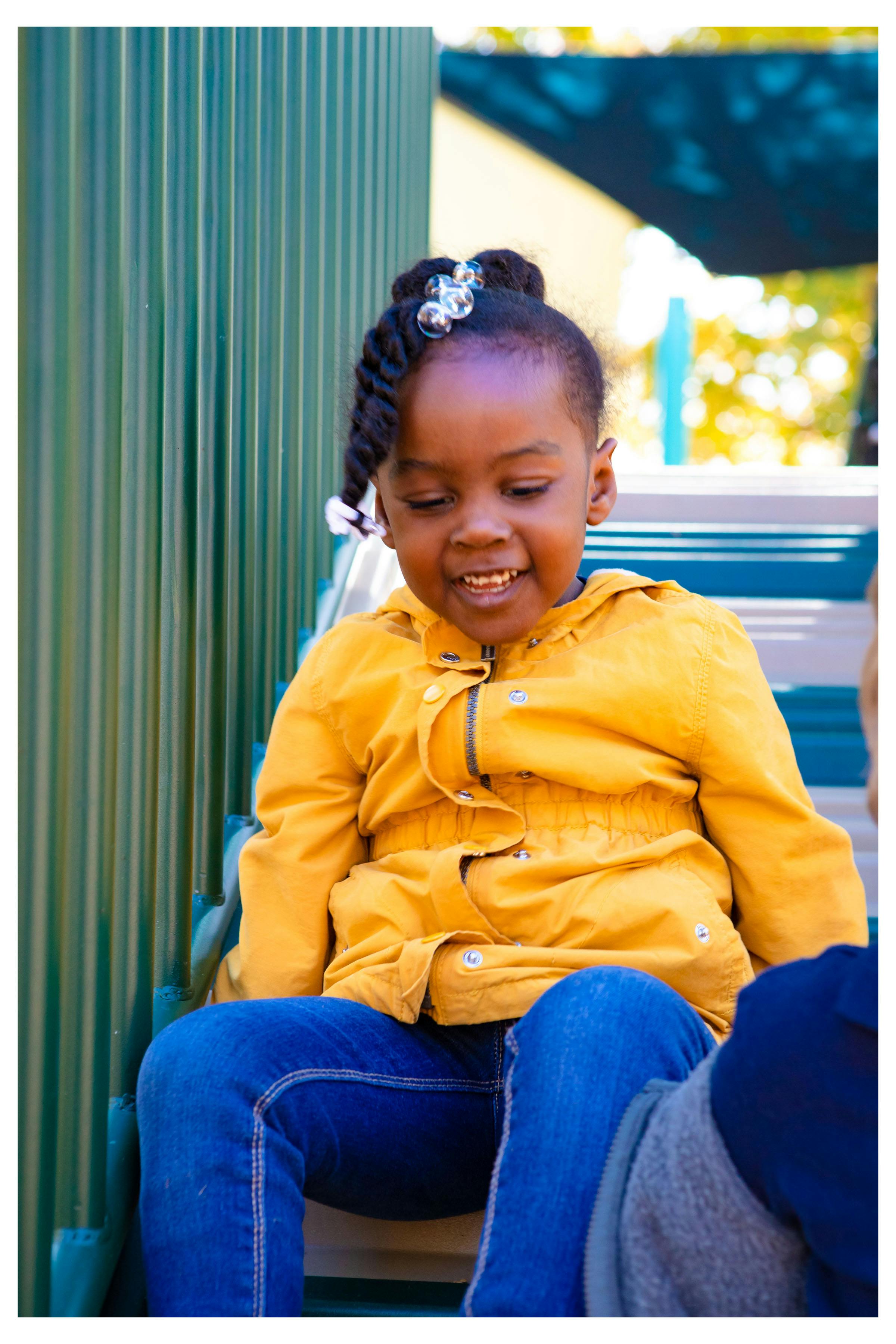 Child sitting on playground equipment