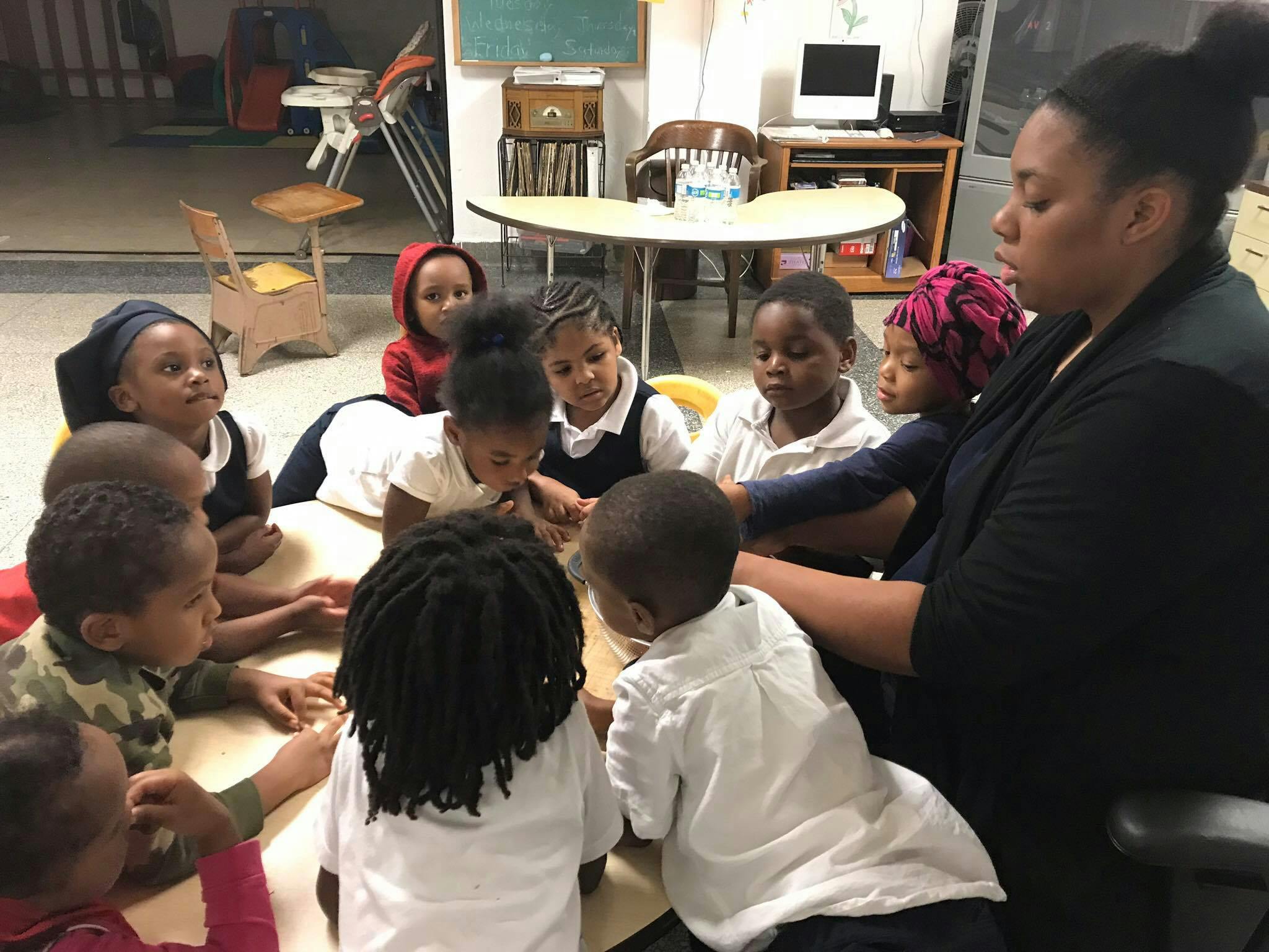 Adult and children gathered around a table