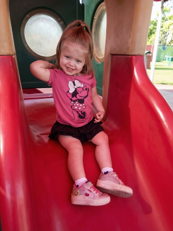Child sitting on a playground slide