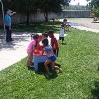 Children playing with a water table outdoors