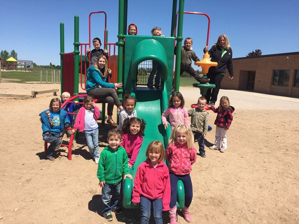 Group of children and adults on a playground structure