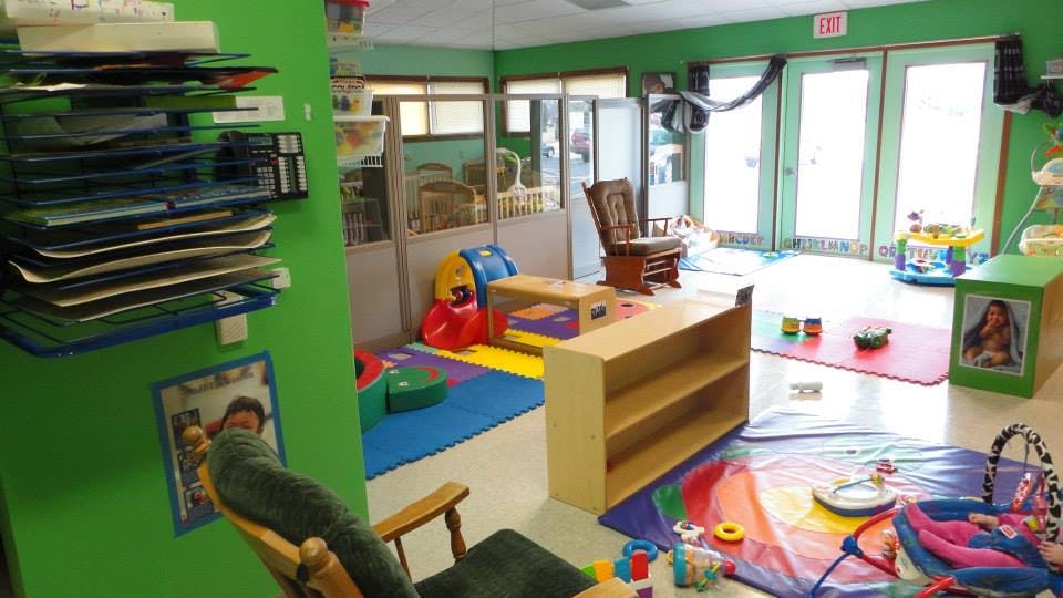 Playroom with colorful mats, toys, and small furniture