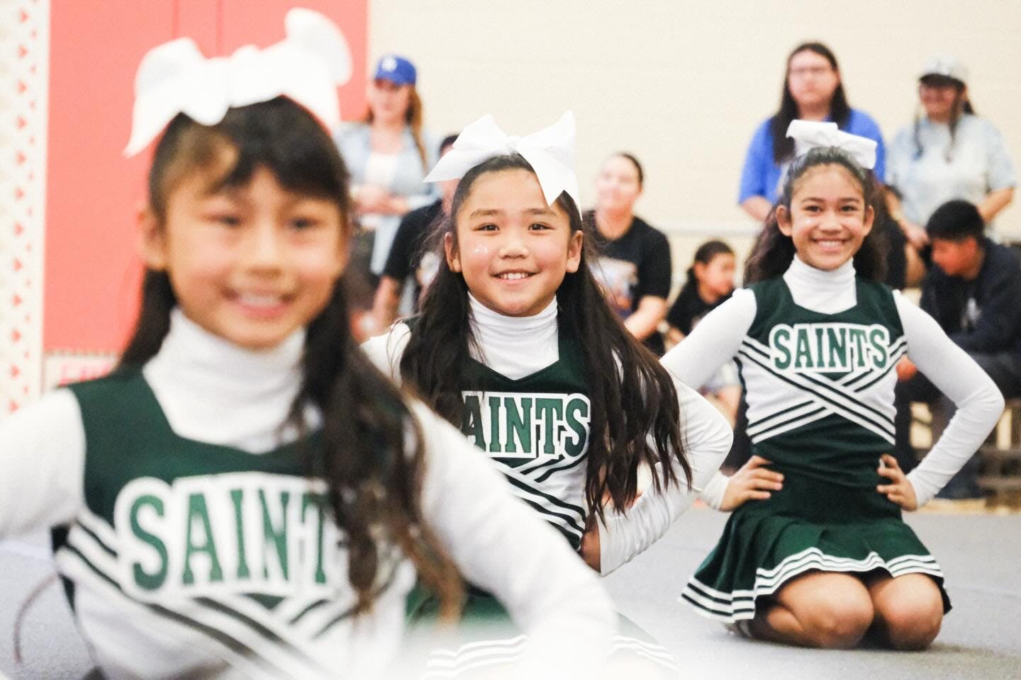 Three children in cheerleading outfits